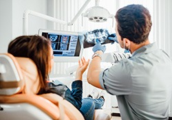 Dentist and patient reviewing X-ray together