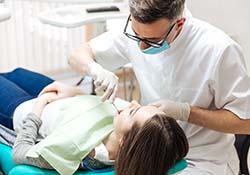 Emergency dentist in Green Hills examining a patient