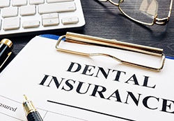 a dental insurance claim form on a clipboard 