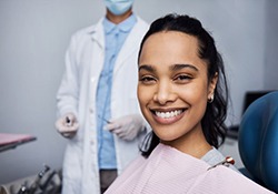 Portrait of smiling young woman in dental treatment chair