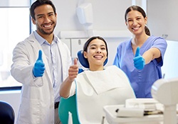 Patient and dental team giving thumbs up