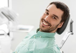 A man smiling in the dentist chair