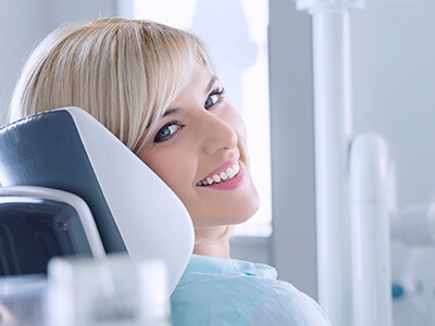 women smiling in dental exam chair