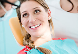 Women in pink smiling at dentist