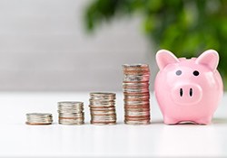 Coins next to a piggy bank